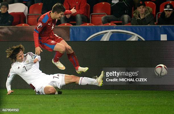 Vaclav Pilar of Czech Republic vies with Janis Ikaunieks of Latvia during the Group A Euro 2016 qualifying football match between Czech Republic and...