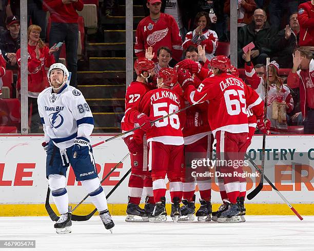 Kyle Quincey, Teemu Pulkkinen, Danny DeKeyser and Stephen Weiss of the Detroit Red Wings congratulate teammate Joakim Andersson after scoring a goal...