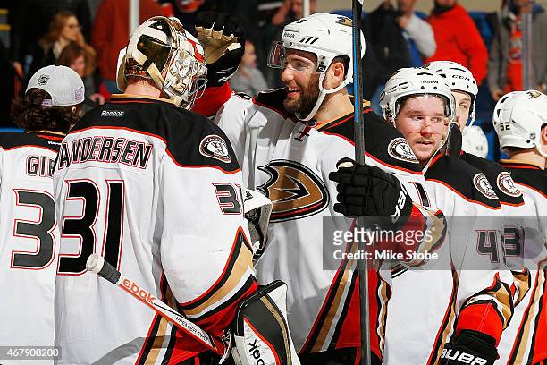 Frederik Andersen of the Anaheim Ducks is congratulated by teammate Patrick Maroon after defeating the New York Islanders at Nassau Veterans Memorial...