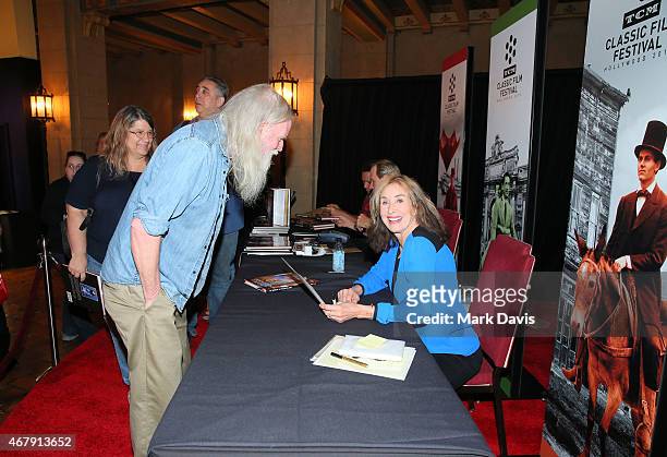 Photographer/author Rory Flynn signs books for a fan during day three of the 2015 TCM Classic Film Festival on March 28, 2015 in Los Angeles,...