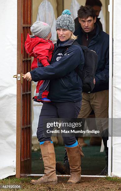 Zara Phillips carries daughter Mia Tindall as she and Harry Meade attend the Gatcombe Horse Trials at Gatcombe Park on March 28, 2015 in Stroud,...