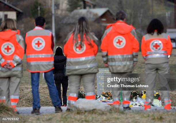 Relative stands at a monument to honour the victims of Germanwings flight 4U9525 in front of the mountains near the crash site on March 26, 2015 in...