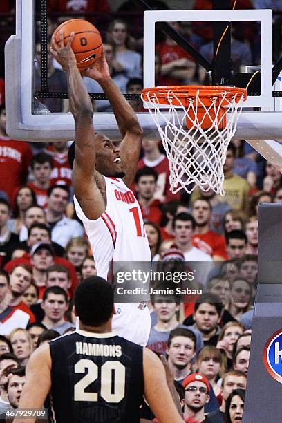 Sam Thompson of the Ohio State Buckeyes finishes off an alley oop pass with a slam dunk over A.J. Hammons of the Purdue Boilermakers in the first...