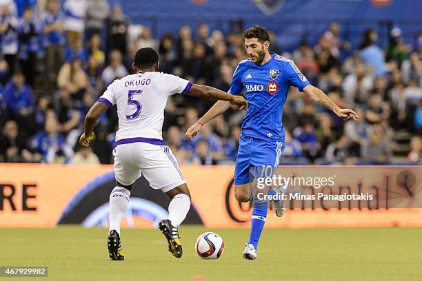 Ignacio Piatti of Montreal Impact looks to play the ball past Amobi Okugo of Orlando City SC during the MLS game at the Olympic Stadium on March 28,...