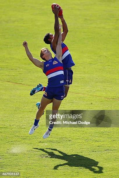 Brett Goodes marks the ball against Lachie Hunter during a Western Bullldogs AFL training session at Victoria University Whitten Oval on February 9,...