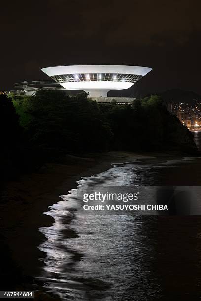 The Niteroi Contemporary Art Museum is lit up before the Earth Hour environmental campaign in Niteroi, a neighbouring city of Rio de Janeiro, Brazil,...