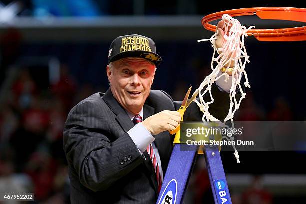 Head coach Bo Ryan of the Wisconsin Badgers cuts the net after the Badgers 85-78 victory against the Arizona Wildcats during the West Regional Final...