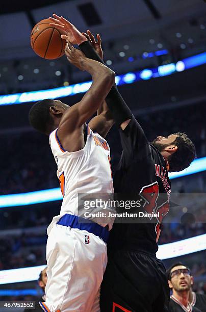 Nikola Mirotic of the Chicago Bulls blocks a shot by Cleanthony Early of the New York Knicks at the United Center on March 28, 2015 in Chicago,...