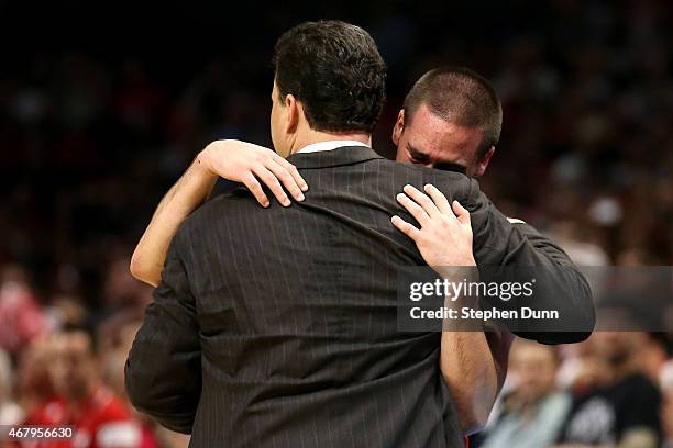 Head coach Sean Miller hugs T.J. McConnell of the Arizona Wildcats late in the second half as McConnell is taken out of the game against the...