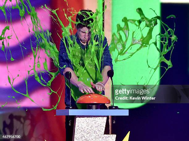 Musician Shawn Mendes gets slimed onstage during Nickelodeon's 28th Annual Kids' Choice Awards held at The Forum on March 28, 2015 in Inglewood,...