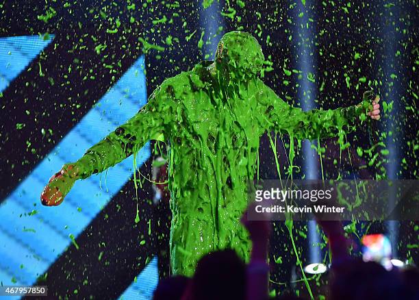Singer Nick Jonas get slimed while accepting award for Favorite Male Singer onstage during Nickelodeon's 28th Annual Kids' Choice Awards held at The...