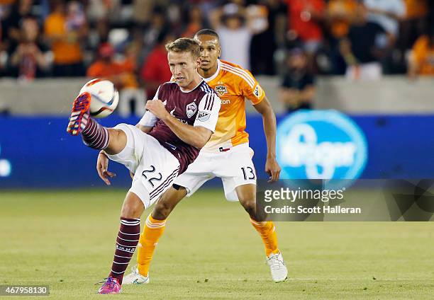Lucas Pittinari of the Colorado Rapids battles for the ball with Ricardo Clark of the Houston Dynamo during their game at BBVA Compass Stadium on...