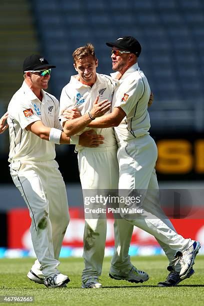 Tim Southee of New Zealand celebrates his wicket of Rohit Sharma of India with Corey Anderson and Peter Fulton during day four of the First Test...