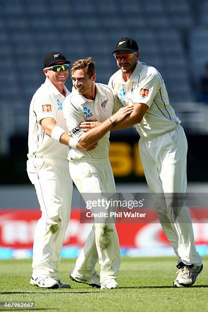 Tim Southee of New Zealand celebrates his wicket of Rohit Sharma of India with Corey Anderson and Peter Fulton during day four of the First Test...