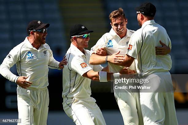 Tim Southee of New Zealand celebrates his wicket of Rohit Sharma of India with Brendon McCullum, Corey Anderson and Peter Fulton during day four of...