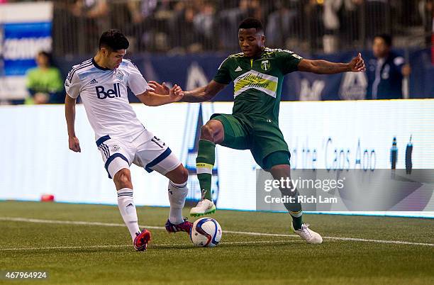 Matias Laba of the Vancouver Whitecaps FC battles with Alvas Powell of the Portland Timbers for the ball in MLS action on March 2015 at BC Place...