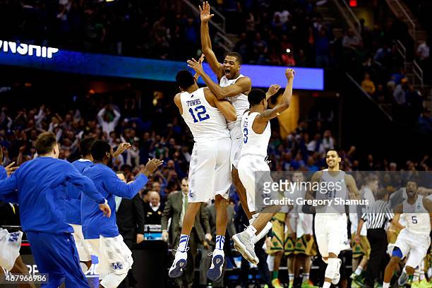 Aaron Harrison of the Kentucky Wildcats celebrates with teammates after defeating the Notre Dame Fighting Irish during the Midwest Regional Final of...