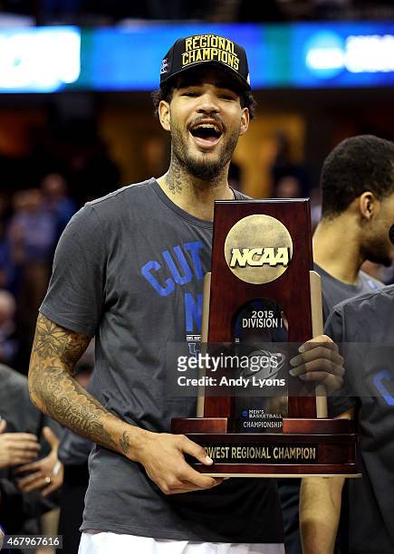 Willie Cauley-Stein of the Kentucky Wildcats holds his team's trophy after defeating the Notre Dame Fighting Irish during the Midwest Regional Final...