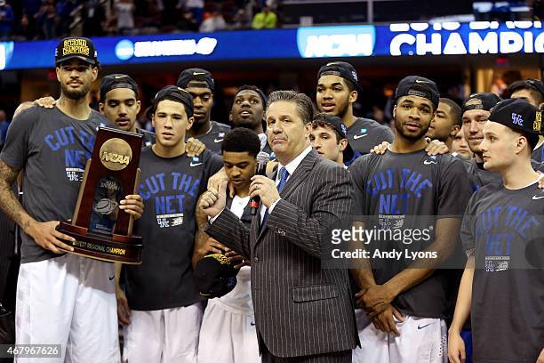 Head coach John Calipari of the Kentucky Wildcats looks on with his team and their trophy after defeating the Notre Dame Fighting Irish during the...