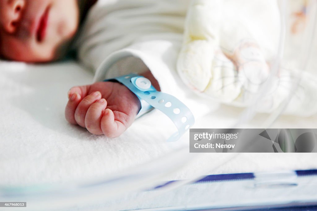 Newborn baby in incubator