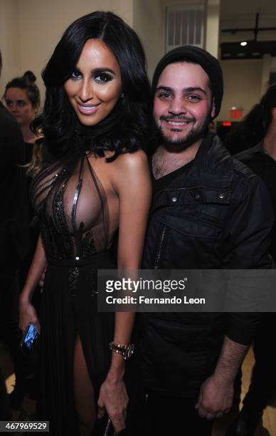 Reality star Lilly Ghalichi and designer Michael Costello pose for pictures backstage following the Michael Costello fashion show at Helen Mills...