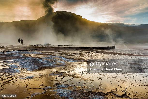 steam rising from geysers, el tatio geyser field - geysir stock-fotos und bilder