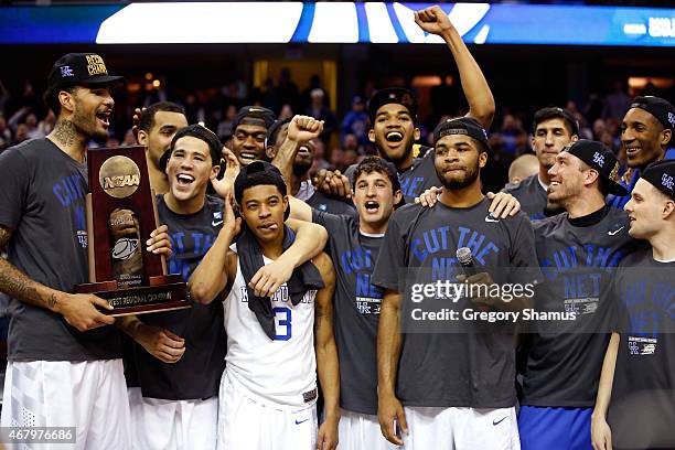 Head coach John Calipari of the Kentucky Wildcats looks on with his team and their trophy after defeating the Notre Dame Fighting Irish during the...