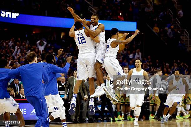 Aaron Harrison of the Kentucky Wildcats celebrates with teammates after defeating the Notre Dame Fighting Irish during the Midwest Regional Final of...
