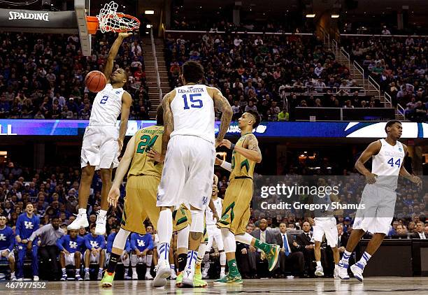 Aaron Harrison of the Kentucky Wildcats dunks the ball against Pat Connaughton of the Notre Dame Fighting Irish during the Midwest Regional Final of...