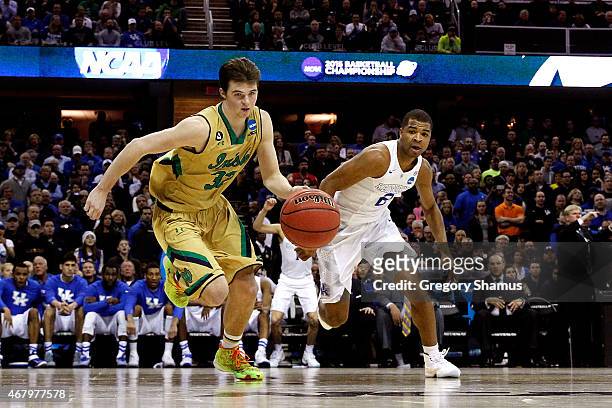 Steve Vasturia of the Notre Dame Fighting Irish goes for a loose ball against Aaron Harrison of the Kentucky Wildcats in the second half during the...
