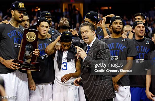 Head coach John Calipari of the Kentucky Wildcats looks on with his team and their trophy after defeating the Notre Dame Fighting Irish during the...