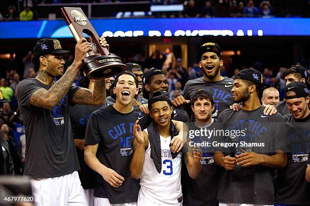 The Kentucky Wildcats celebrate with their trophy after defeating the Notre Dame Fighting Irish during the Midwest Regional Final of the 2015 NCAA...