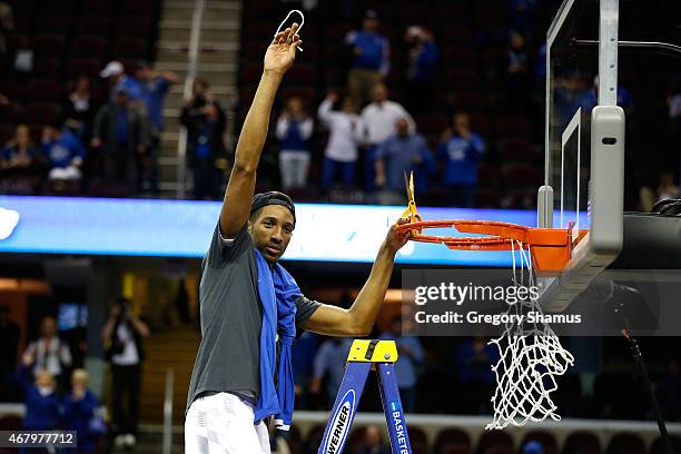 Marcus Lee of the Kentucky Wildcats cuts down the net after defeating the Notre Dame Fighting Irish during the Midwest Regional Final of the 2015...