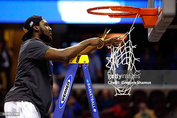 Dominique Hawkins of the Kentucky Wildcats cuts down the net after defeating the Notre Dame Fighting Irish during the Midwest Regional Final of the...