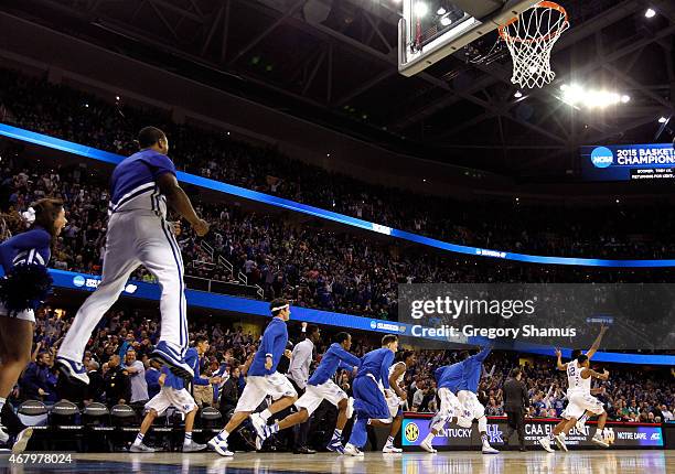 The Kentucky Wildcats bench and cheerleaders celebrate after defeating the Notre Dame Fighting Irish during the Midwest Regional Final of the 2015...