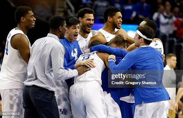 The Kentucky Wildcats celebrate after defeating the Notre Dame Fighting Irish during the Midwest Regional Final of the 2015 NCAA Men's Basketball...