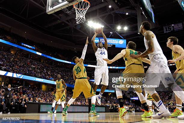 Dakari Johnson of the Kentucky Wildcats shoots against Zach Auguste of the Notre Dame Fighting Irish in the second half during the Midwest Regional...