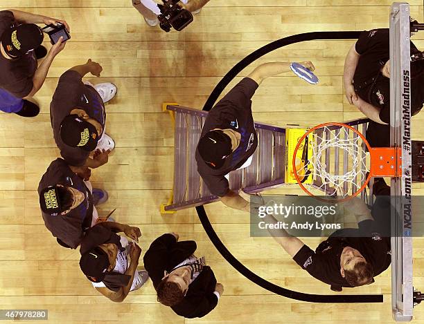 Devin Booker of the Kentucky Wildcats cuts down the net after defeating the Notre Dame Fighting Irish during the Midwest Regional Final of the 2015...