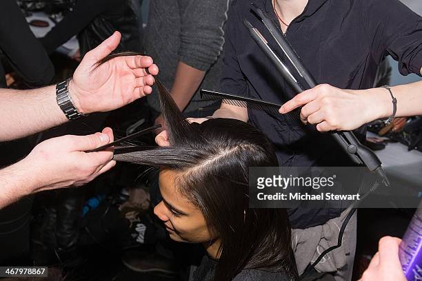 Model prepares before the Mara Hoffman show during Mercedes-Benz Fashion Week Fall 2014 at The Salon at Lincoln Center on February 8, 2014 in New...