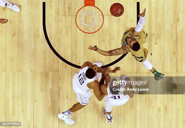 Zach Auguste of the Notre Dame Fighting Irish drives to the basket against Karl-Anthony Towns and Trey Lyles of the Kentucky Wildcats during the...