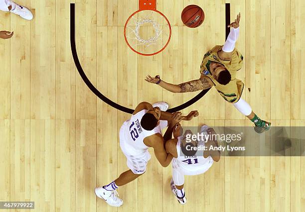 Zach Auguste of the Notre Dame Fighting Irish drives to the basket against Karl-Anthony Towns and Trey Lyles of the Kentucky Wildcats during the...