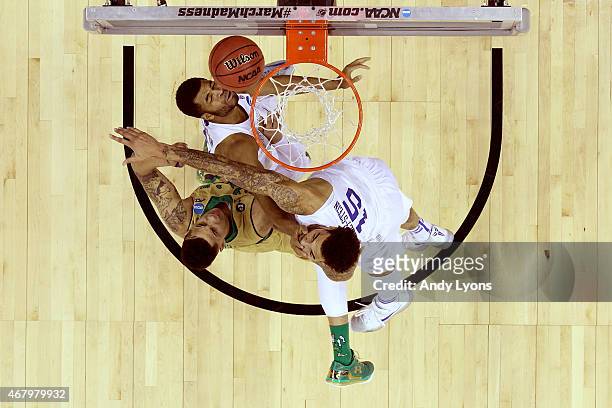 Zach Auguste of the Notre Dame Fighting Irish goes up for the ball against Andrew Harrison and Willie Cauley-Stein of the Kentucky Wildcats during...