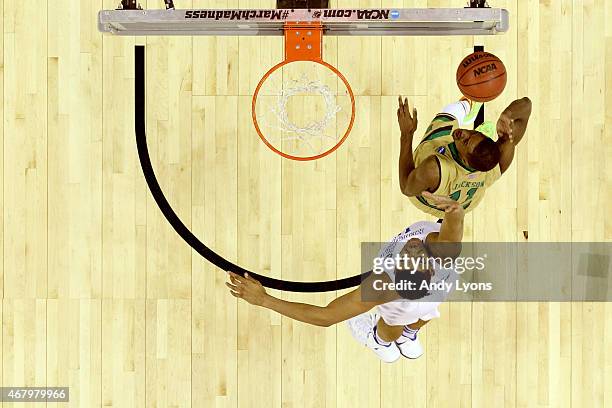 Demetrius Jackson of the Notre Dame Fighting Irish drives to the basket against Karl-Anthony Towns of the Kentucky Wildcats in the second half during...