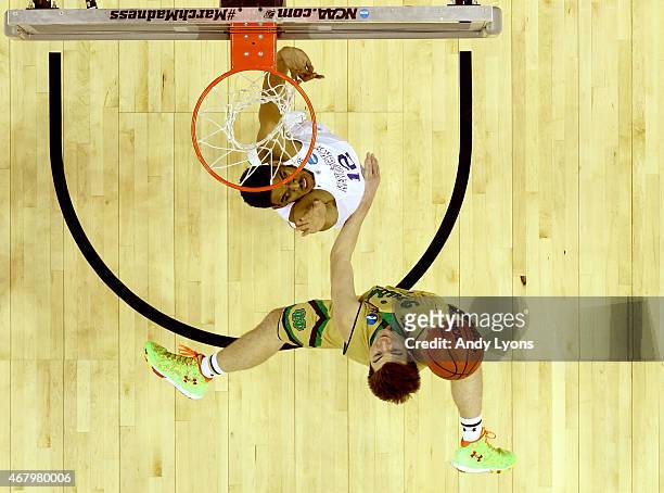 Steve Vasturia of the Notre Dame Fighting Irish shoots against Karl-Anthony Towns of the Kentucky Wildcats in the second half during the Midwest...
