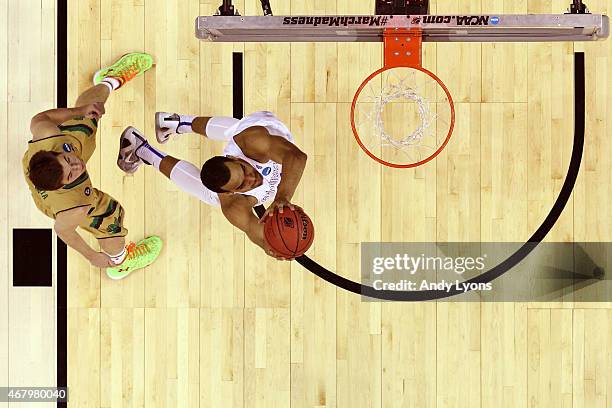 Trey Lyles of the Kentucky Wildcats drives to the basket against Steve Vasturia of the Notre Dame Fighting Irish in the first half during the Midwest...