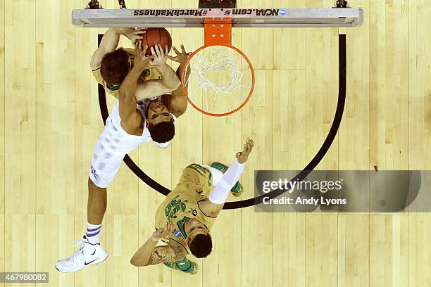 Karl-Anthony Towns of the Kentucky Wildcats goes for a rebound against Pat Connaughton and Zach Auguste of the Notre Dame Fighting Irish during the...