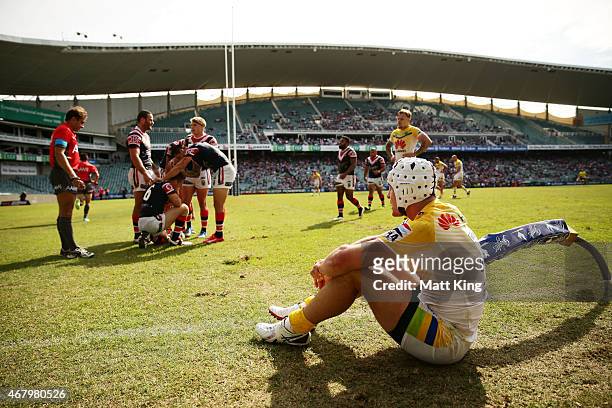 James Maloney of the Roosters celebrates with team mates after scoring a try as Jarrod Croker of the Raiders looks dejected during the round four NRL...
