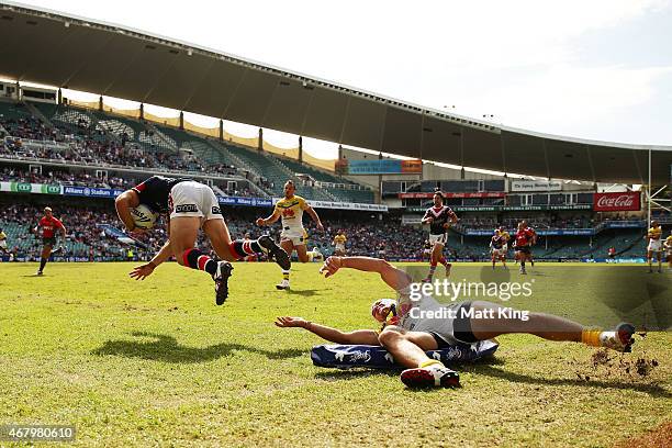 James Maloney of the Roosters beats Jarrod Croker of the Raiders to score a try during the round four NRL match between the Sydney Roosters and the...