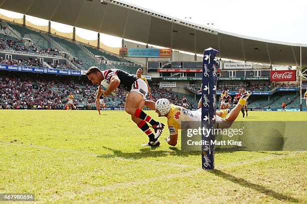 James Maloney of the Roosters beats Jarrod Croker of the Raiders to score a try during the round four NRL match between the Sydney Roosters and the...
