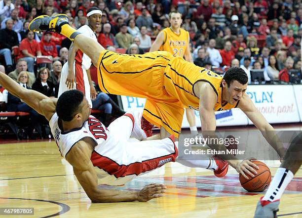 Larry Nance Jr. #22 of the Wyoming Cowboys falls to the court after being fouled by Khem Birch of the UNLV Rebels during their game at the Thomas &...